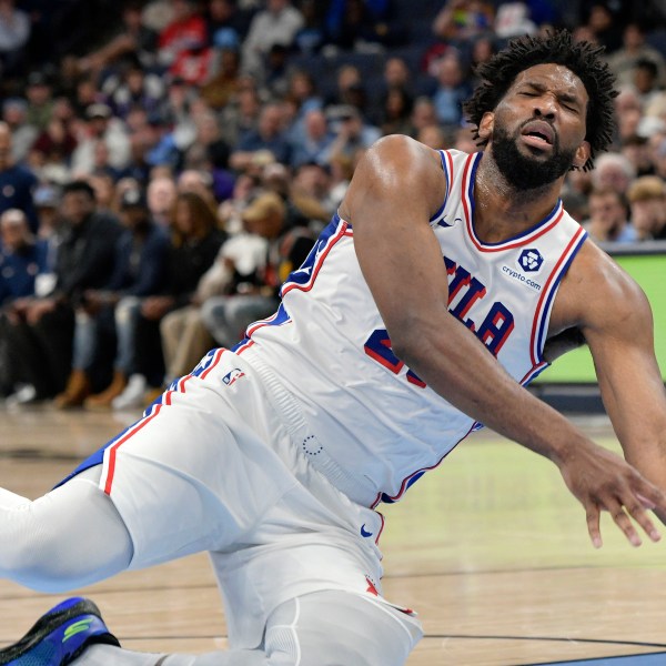 Philadelphia 76ers center Joel Embiid falls to the court in the second half of an NBA basketball game against the Memphis Grizzlies Wednesday, Nov. 20, 2024, in Memphis, Tenn. (AP Photo/Brandon Dill)