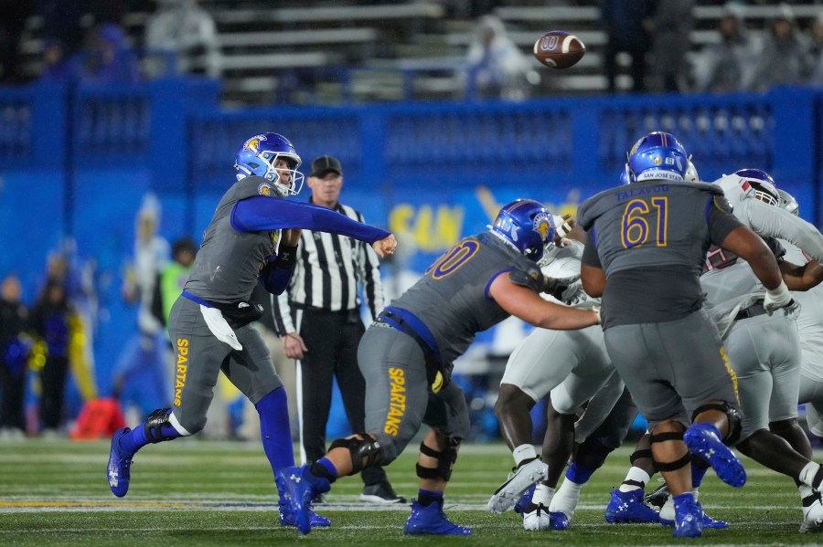 San Jose State quarterback Walker Eget, left, passes during the first half of an NCAA college football game against UNLV, Friday, Nov. 22, 2024, in San Jose, Calif. (AP Photo/Godofredo A. Vásquez)