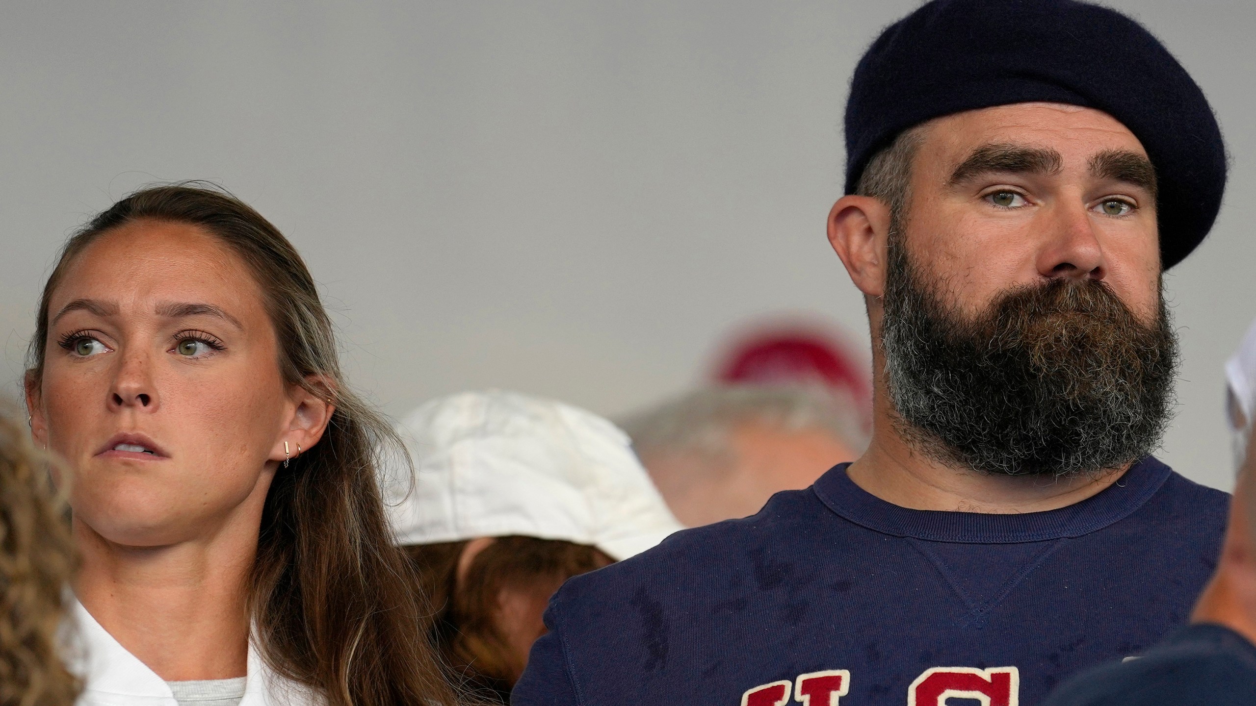 FILE- Jason Kelce and wife Kylie watch the women's field hockey match between the Argentina and United States, at the Yves-du-Manoir Stadium, at the 2024 Summer Olympics, Saturday, July 27, 2024, in Colombes, France. (AP Photo/Anjum Naveed, File)