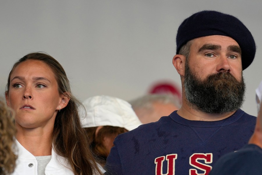 FILE- Jason Kelce and wife Kylie watch the women's field hockey match between the Argentina and United States, at the Yves-du-Manoir Stadium, at the 2024 Summer Olympics, Saturday, July 27, 2024, in Colombes, France. (AP Photo/Anjum Naveed, File)