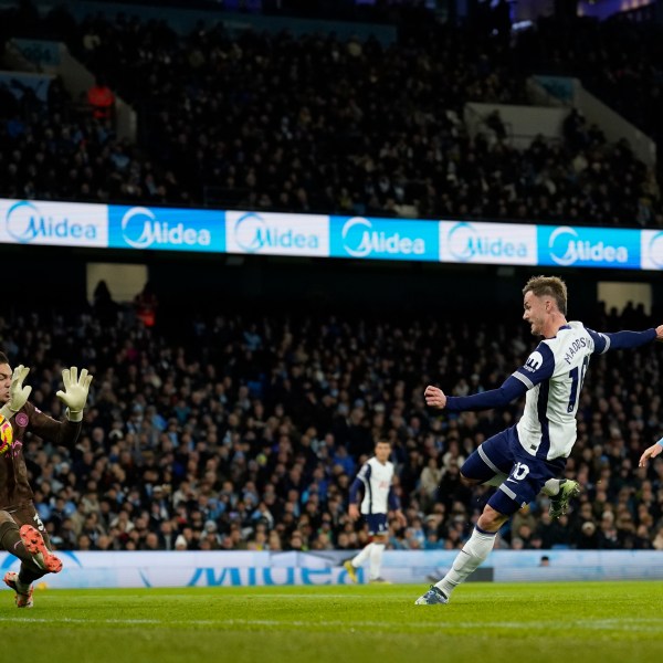 Tottenham's James Maddison, 2nd from right, scores the opening goal during the English Premier League soccer match between Manchester City and Tottenham at the Etihad Stadium in Manchester, England, Sunday, Nov. 24, 2024. (AP Photo/Dave Thompson)