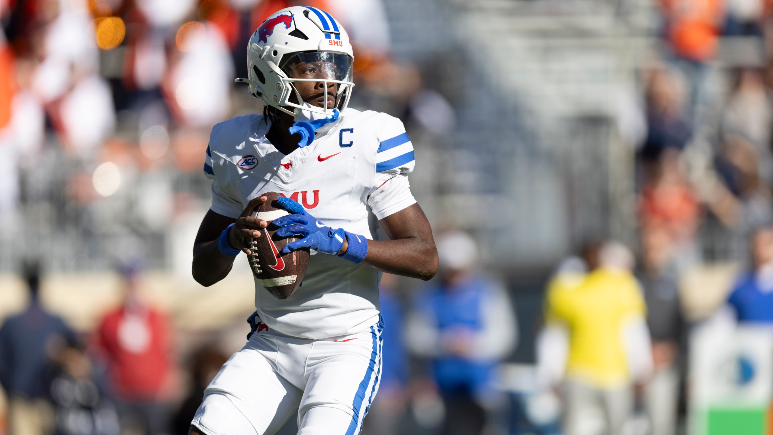 SMU quarterback Kevin Jennings (7) looks to pass during the first half of an NCAA college football game against Virginia, Saturday, Nov. 23, 2024, in Charlottesville, Va. (AP Photo/Mike Kropf)