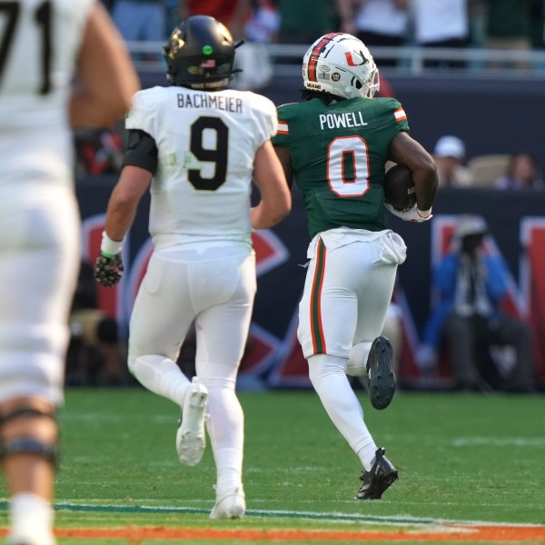 Miami defensive back Mishael Powell (0) runs back an interception to score a touchdown during the first half of an NCAA college football game against against Wake Forest, Saturday, Nov. 23, 2024, in Miami Gardens, Fla. (AP Photo/Lynne Sladky)