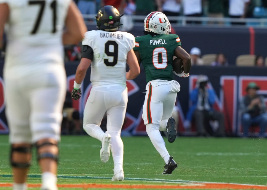 Miami defensive back Mishael Powell (0) runs back an interception to score a touchdown during the first half of an NCAA college football game against against Wake Forest, Saturday, Nov. 23, 2024, in Miami Gardens, Fla. (AP Photo/Lynne Sladky)