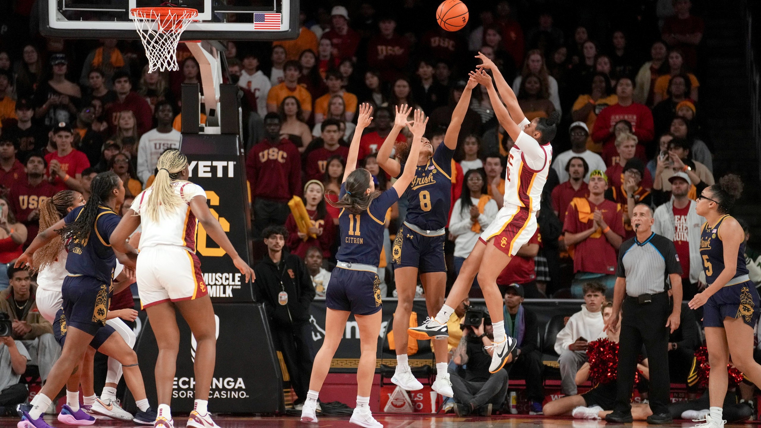 Southern California guard JuJu Watkins (12) shoots over Notre Dame guards Cassandre Prosper (8) and Sonia Citron (11) during the first half of an NCAA college basketball game, Saturday, Nov. 23, 2024 in Los Angeles. (AP Photo/Eric Thayer)