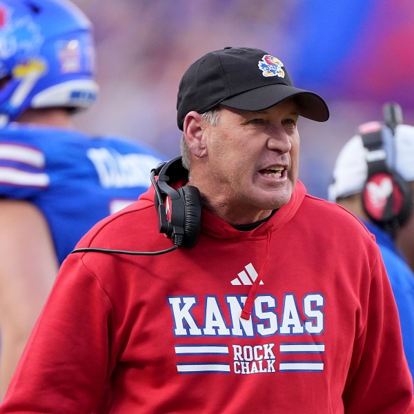 Kansas head coach Lance Leipold talks to his players during the first half of an NCAA college football game against Colorado, Saturday, Nov. 23, 2024, in Kansas City, Mo. (AP Photo/Charlie Riedel)