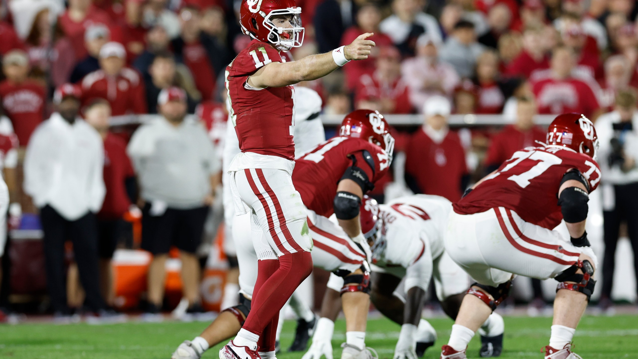 Oklahoma quarterback Jackson Arnold (11) gestures to his team before a play against Alabama during the second quarter of a NCAA college football game Saturday, Nov. 23, 2024, in Norman, Okla. (AP Photo/Alonzo Adams)