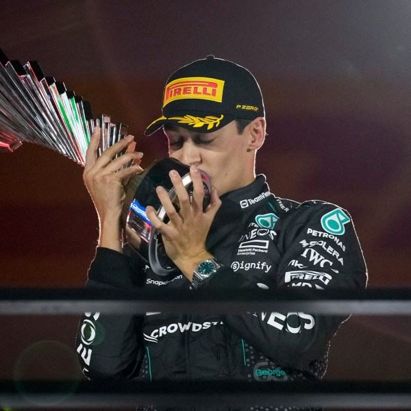 Mercedes driver George Russell, of Britain, celebrates on the podium after winning during the F1 Las Vegas Grand Prix auto race, Saturday, Nov. 23, 2024, in Las Vegas. (AP Photo/John Locher)