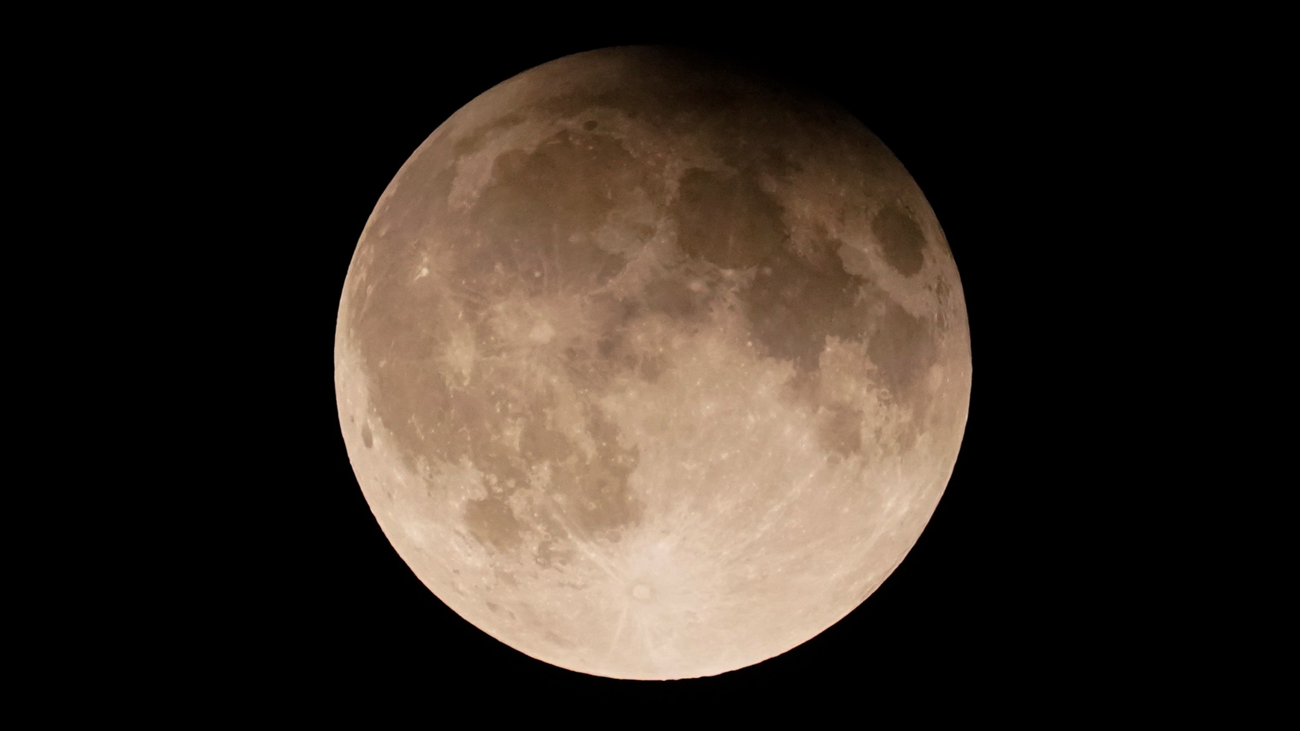 FILE - A supermoon with a partial lunar eclipse rises over Lake Michigan in Chicago, Sept. 17, 2024. (AP Photo/Kiichiro Sato, File)