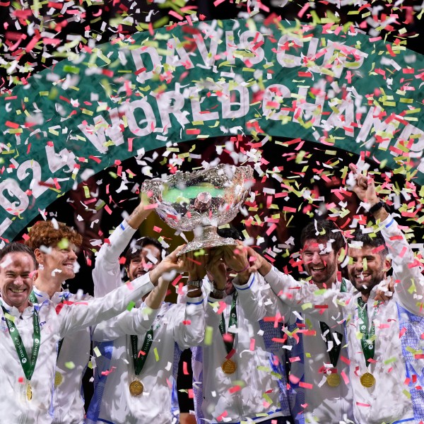 Italian tennis team members hold the Davis Cup trophy after the final between Netherlands and Italy at the Martin Carpena Sports Hall in Malaga, southern Spain, as Italy wins its second consecutive Davis Cup title, Sunday, Nov. 24, 2024. (AP Photo/Manu Fernandez)