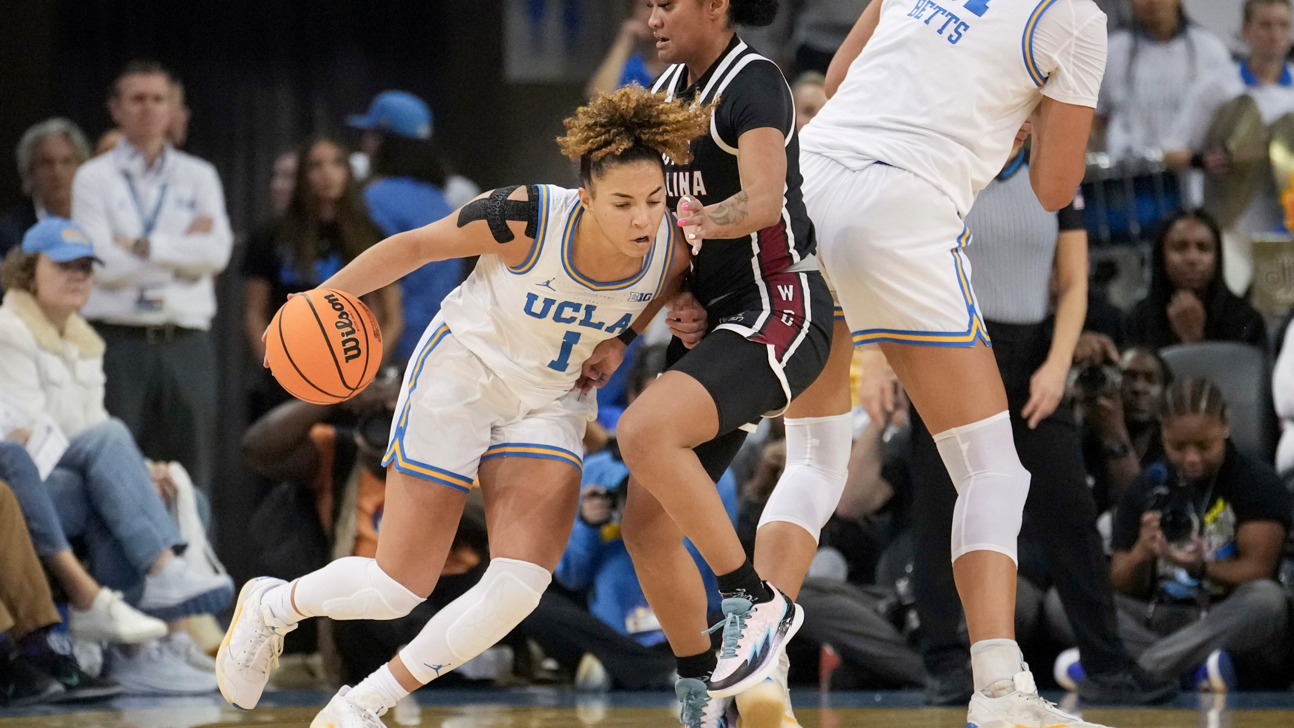 UCLA guard Kiki Rice (1) dribbles against South Carolina guard Te-Hina Paopao (0) during the first half of an NCAA college basketball game, Sunday, Nov. 24, 2024, in Los Angeles. (AP Photo/Eric Thayer)