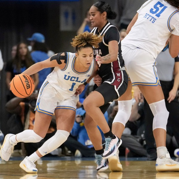 UCLA guard Kiki Rice (1) dribbles against South Carolina guard Te-Hina Paopao (0) during the first half of an NCAA college basketball game, Sunday, Nov. 24, 2024, in Los Angeles. (AP Photo/Eric Thayer)