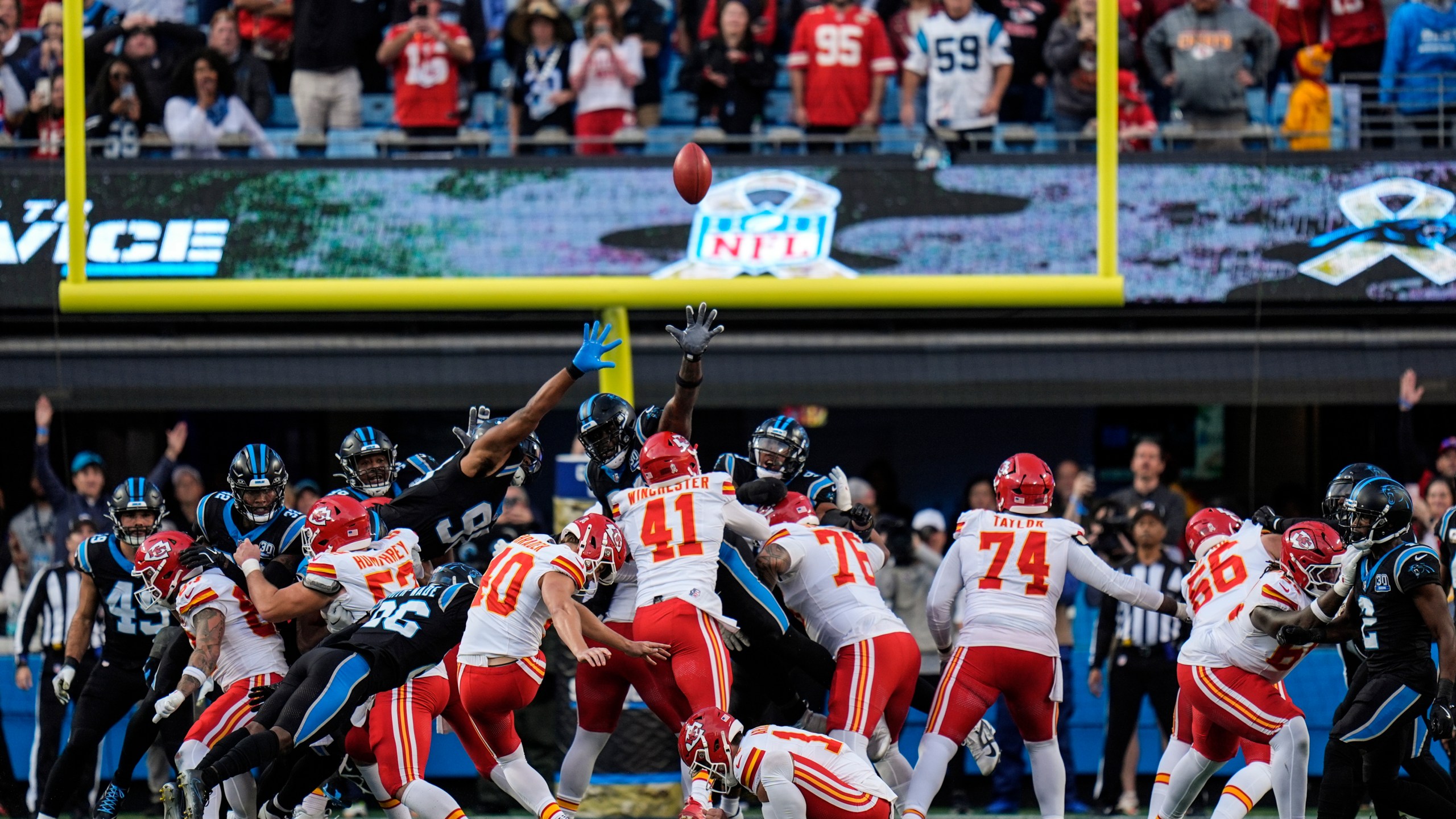 Kansas City Chiefs place kicker Spencer Shrader (40) kicks the game-winning field goal in overtime during an NFL football game against the Carolina Panthers, Sunday, Nov. 24, 2024, in Charlotte, N.C. (AP Photo/Rusty Jones)