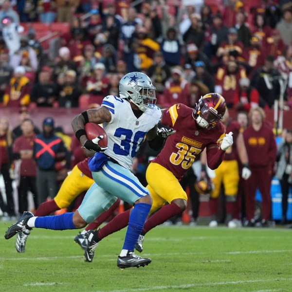 Dallas Cowboys safety Juanyeh Thomas (30) celebrates after scoring a 43-yard touchdown off a kickoff return during the second half of an NFL football game against the Washington Commanders, Sunday, Nov. 24, 2024, in Landover, Md. (AP Photo/Stephanie Scarbrough)