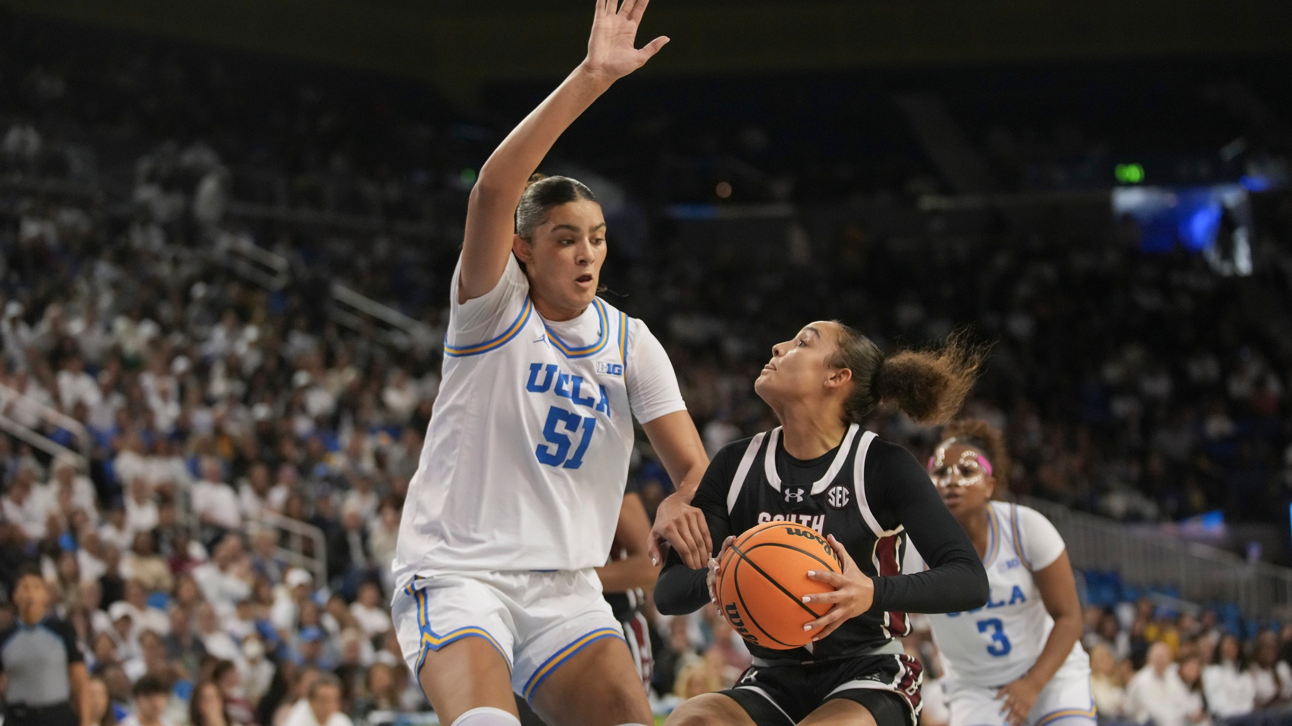 South Carolina guard Tessa Johnson drives against UCLA center Lauren Betts (51) during the first half of an NCAA college basketball game, Sunday, Nov. 24, 2024, in Los Angeles. (AP Photo/Eric Thayer)