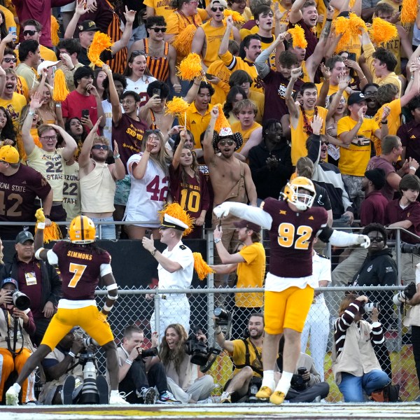 Arizona State defensive back Shamari Simmons (7) and defensive lineman Zac Swanson (92) celebrate an interception against BYU during the second half of an NCAA college football game Saturday, Nov. 23, 2024, in Tempe, Ariz. Arizona State won 28-23. (AP Photo/Ross D. Franklin)