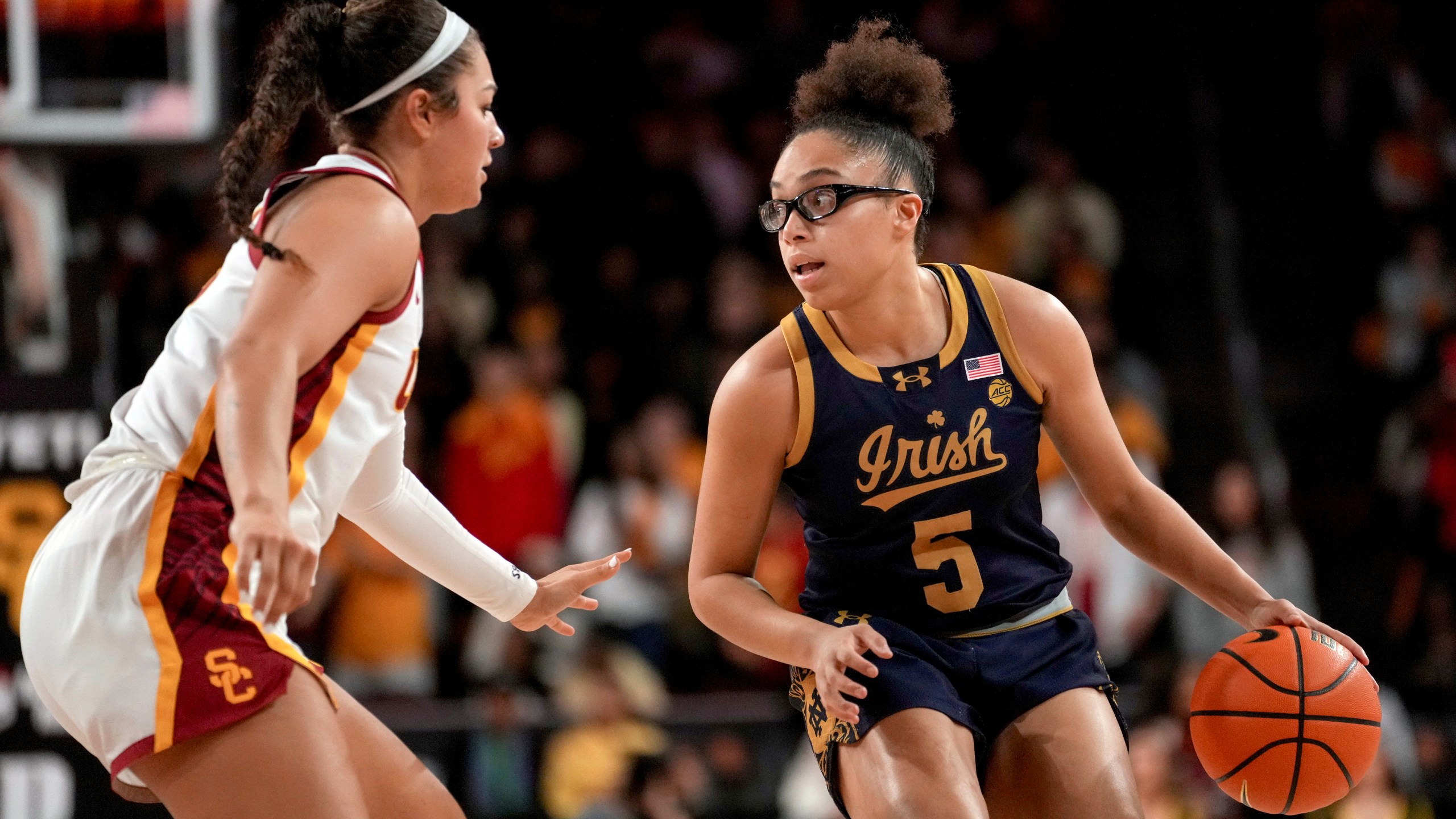 Notre Dame guard Olivia Miles (5) dribbles against Southern California guard Talia von Oelhoffen during the first half of an NCAA college basketball game, Saturday, Nov. 23, 2024 in Los Angeles. (AP Photo/Eric Thayer)