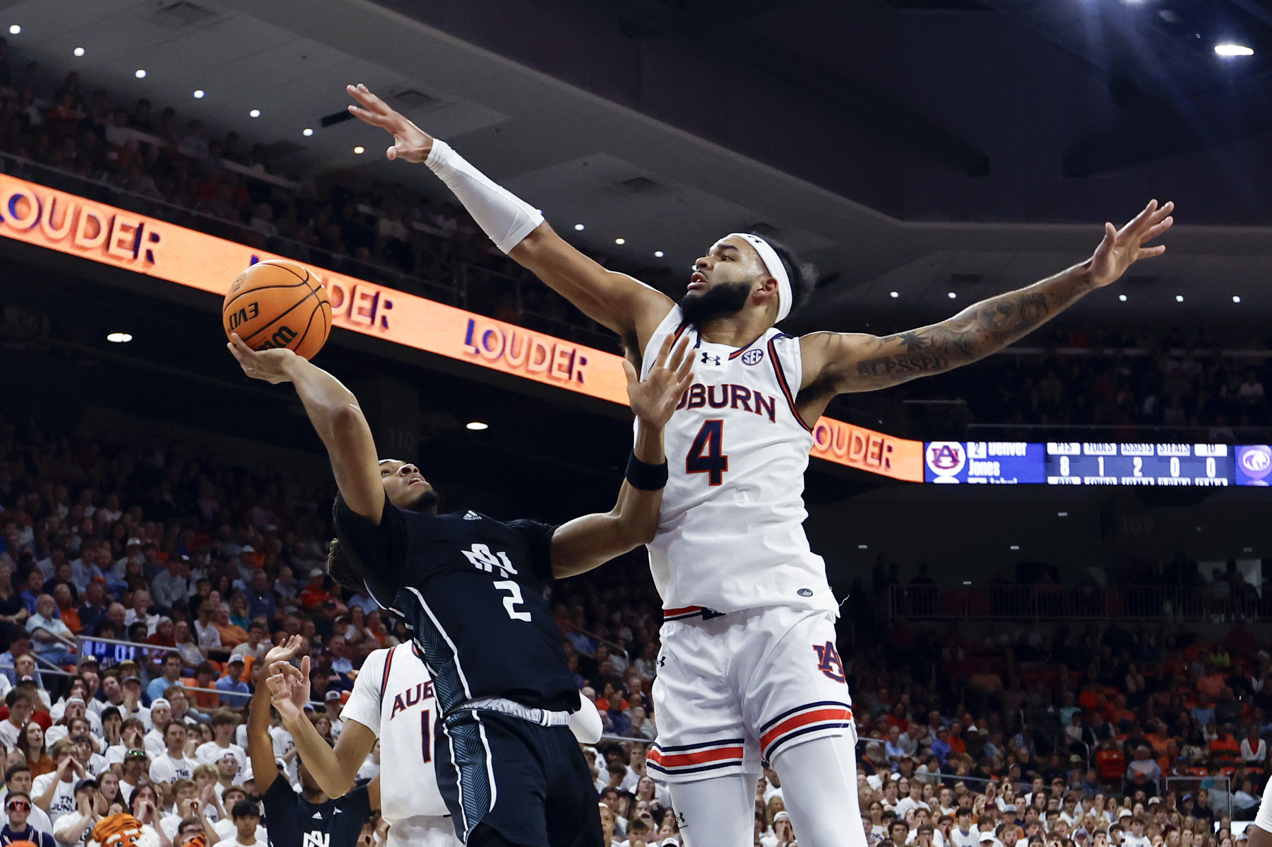 North Alabama guard Daniel Ortiz (2) shoots as Auburn forward Johni Broome (4) tries to block the shot during the first half of an NCAA college basketball game, Monday, Nov. 18, 2024, in Auburn, Ala. (AP Photo/Butch Dill)