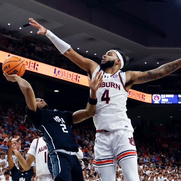 North Alabama guard Daniel Ortiz (2) shoots as Auburn forward Johni Broome (4) tries to block the shot during the first half of an NCAA college basketball game, Monday, Nov. 18, 2024, in Auburn, Ala. (AP Photo/Butch Dill)