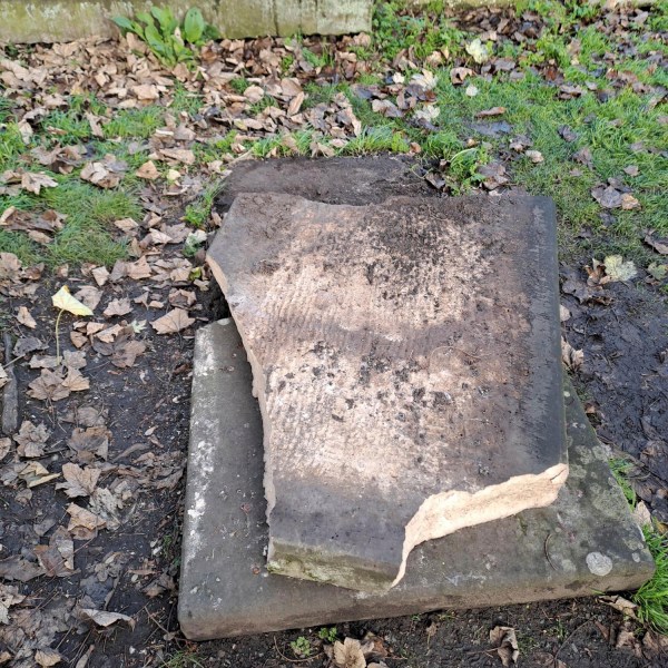 In this picture, provided by the West Mercia Police on Monday, Nov. 25, 2024, a smashed movie prop tombstone that was used for the "A Christmas Carol" movie is seen in Shrewsbury, England. (West Mercia Police via AP)