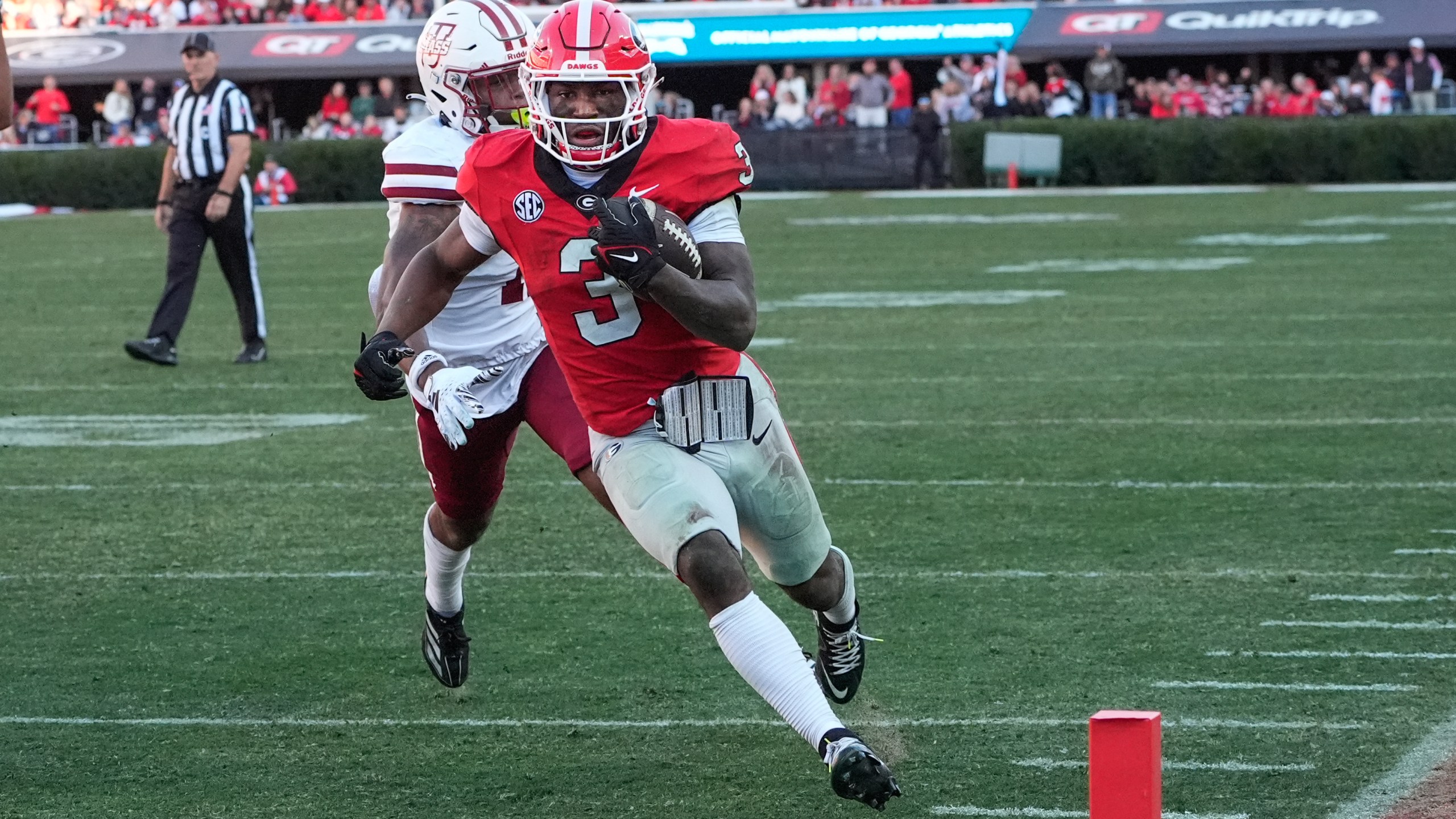 Georgia running back Nate Frazier (3) out runs UMass defensive back Leonard St. Gourdin (11) to the end zone for a tochdown during the second half of an NCAA college football game, Saturday, Nov. 23, 2024, in Athens, Ga. (AP Photo/John Bazemore)