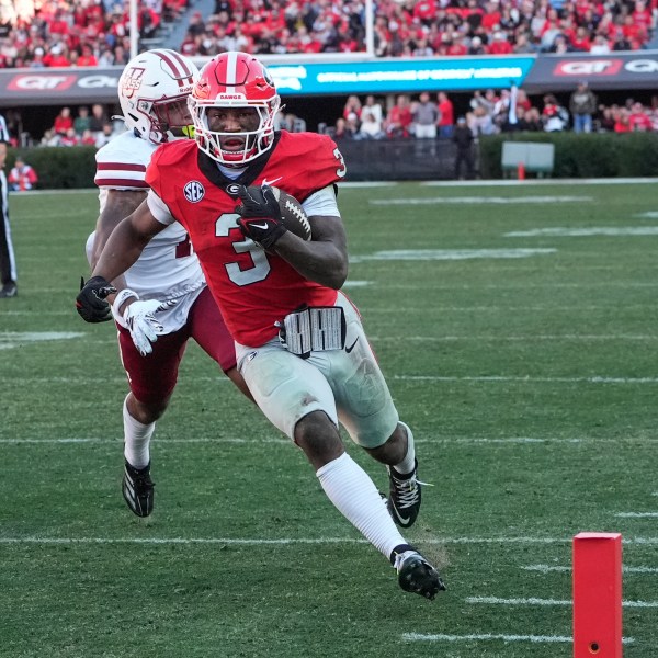 Georgia running back Nate Frazier (3) out runs UMass defensive back Leonard St. Gourdin (11) to the end zone for a tochdown during the second half of an NCAA college football game, Saturday, Nov. 23, 2024, in Athens, Ga. (AP Photo/John Bazemore)