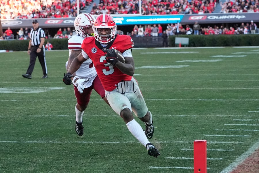 Georgia running back Nate Frazier (3) out runs UMass defensive back Leonard St. Gourdin (11) to the end zone for a tochdown during the second half of an NCAA college football game, Saturday, Nov. 23, 2024, in Athens, Ga. (AP Photo/John Bazemore)