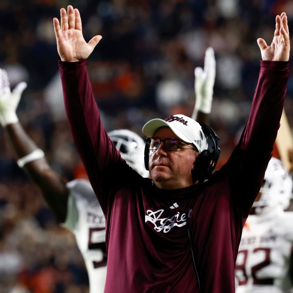 Texas A&M head coach Mike Elko reacts after a touchdown against Auburn during the first half of an NCAA college football game, Saturday, Nov. 23, 2024, in Auburn, Ala. (AP Photo/Butch Dill)