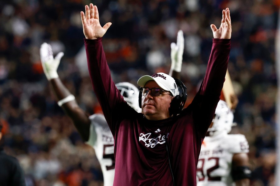 Texas A&M head coach Mike Elko reacts after a touchdown against Auburn during the first half of an NCAA college football game, Saturday, Nov. 23, 2024, in Auburn, Ala. (AP Photo/Butch Dill)