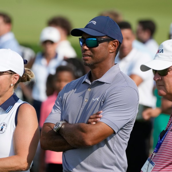 FILE - Tiger Woods watches his son Charlie Woods during the second round of stroke play at the U.S. Junior Amateur Golf Championship on July 23, 2024, in Bloomfield Township, Mich. (AP Photo/Carlos Osorio, File)