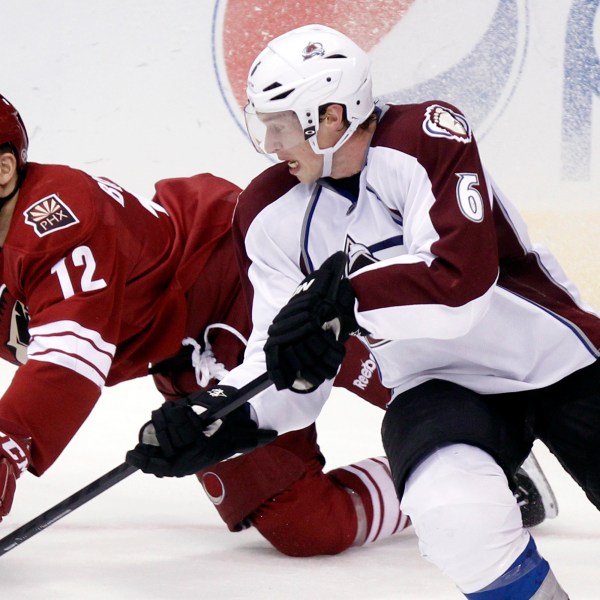 FILE - Phoenix Coyotes left winger Paul Bissonnette, left, and Colorado Avalanche defenseman Erik Johnson, right, compete for the puck in the third period of an NHL hockey game, April 6, 2013, in Glendale, Ariz. (AP Photo/Paul Connors, File)