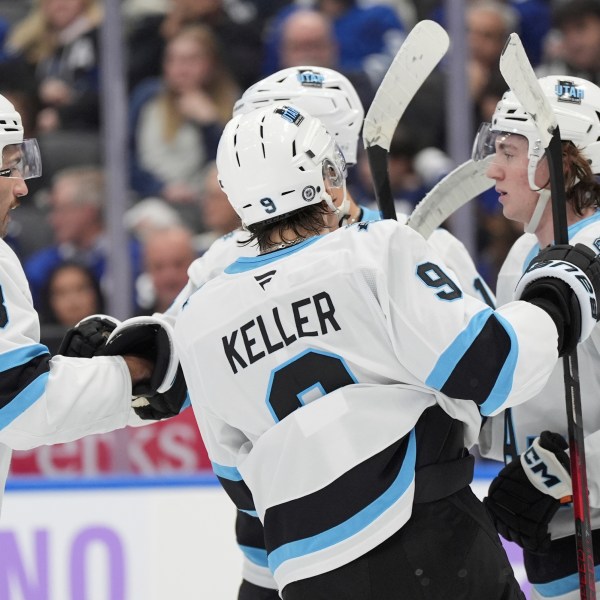 Utah Hockey Club centre Logan Cooley (92) celebrates his goal against the Toronto Maple Leafs with teammates during the first period of an NHL hockey game in Toronto, Sunday, Nov. 24, 2024. (Frank Gunn/The Canadian Press via AP)