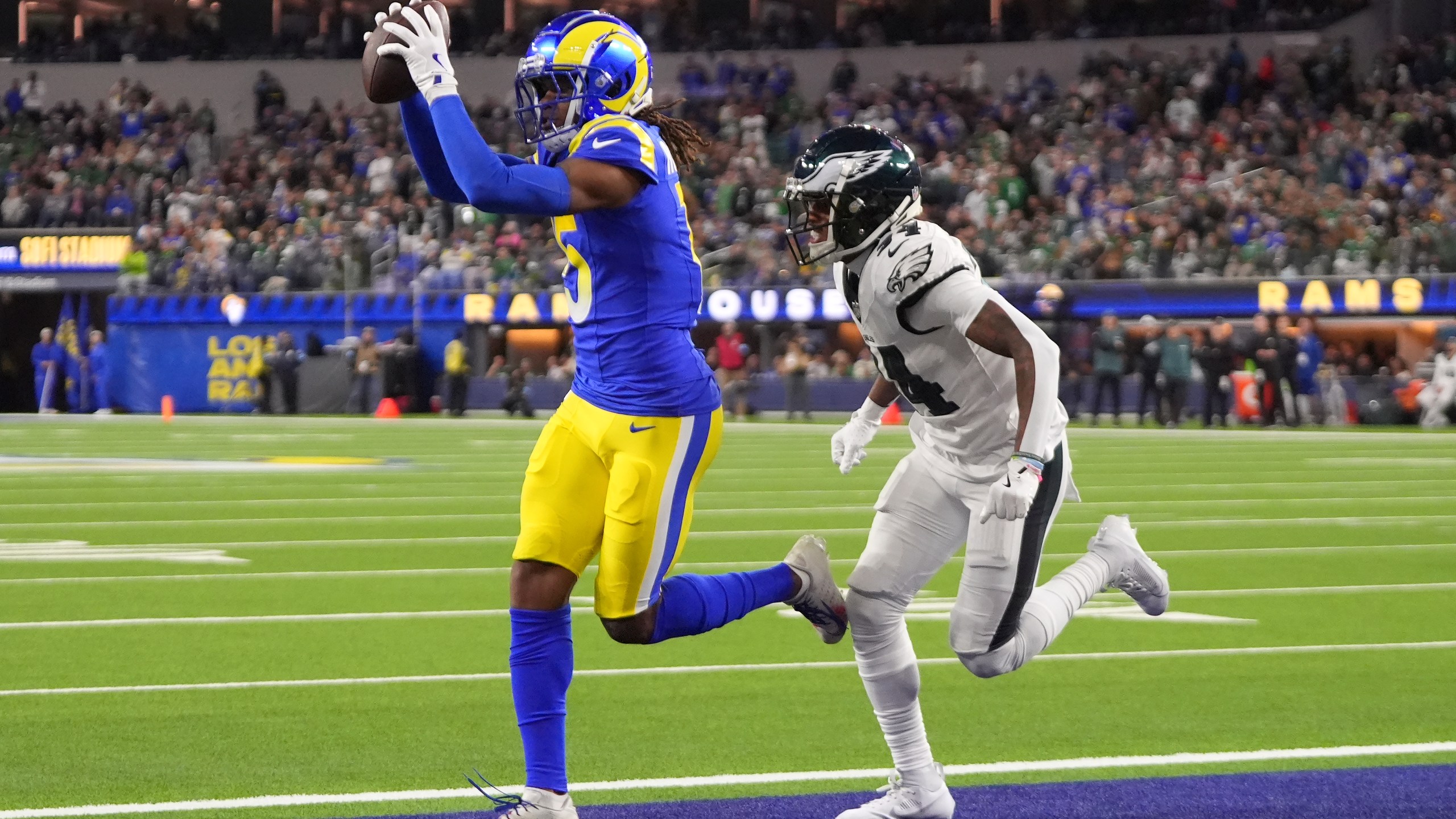 Los Angeles Rams wide receiver Demarcus Robinson, left, catches a touchdown in front of Philadelphia Eagles cornerback Isaiah Rodgers during the second half of an NFL football game in Inglewood, Calif., Sunday, Nov. 24, 2024. (AP Photo/Mark J. Terrill)