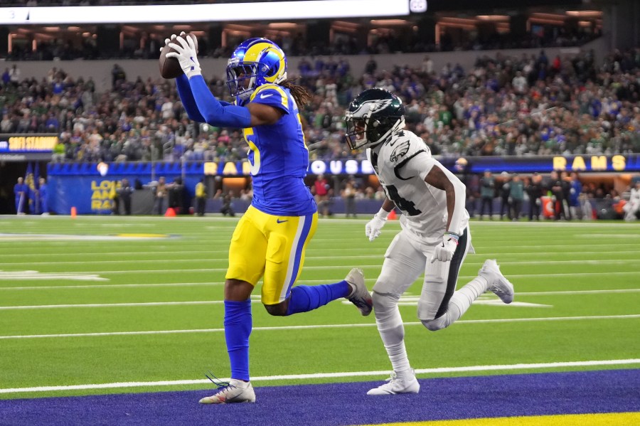 Los Angeles Rams wide receiver Demarcus Robinson, left, catches a touchdown in front of Philadelphia Eagles cornerback Isaiah Rodgers during the second half of an NFL football game in Inglewood, Calif., Sunday, Nov. 24, 2024. (AP Photo/Mark J. Terrill)