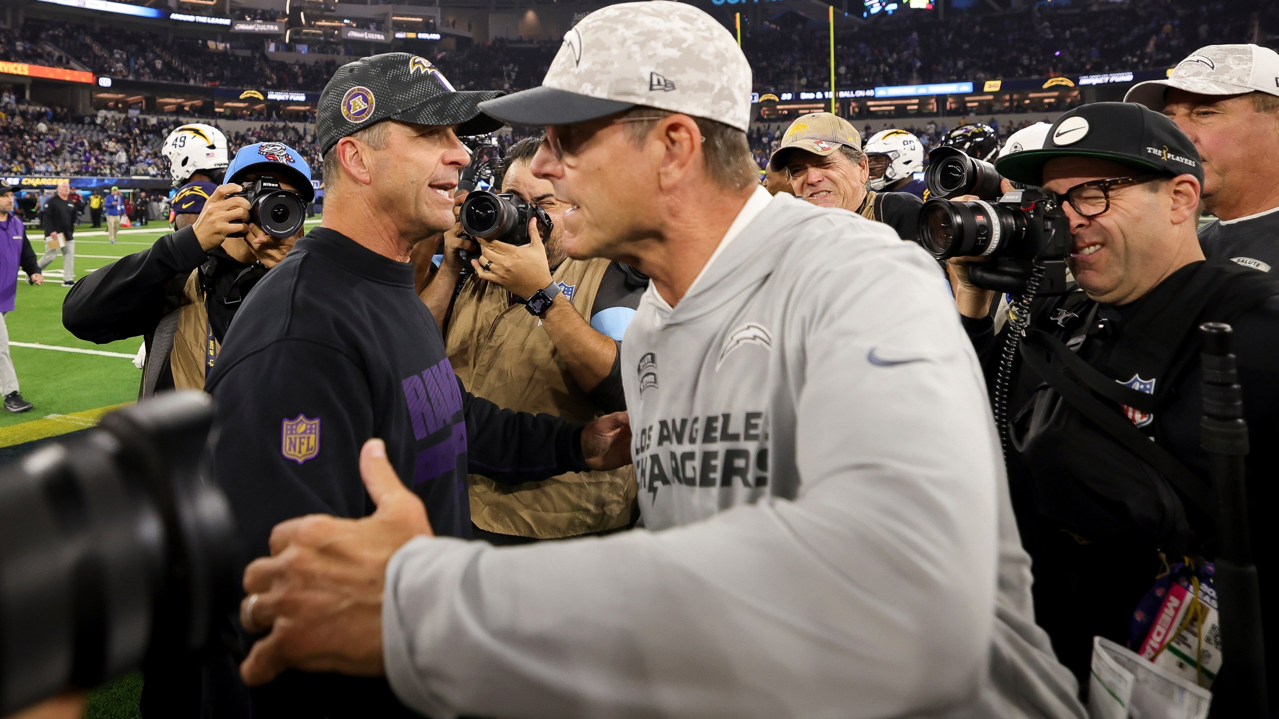 Baltimore Ravens Head Coach John Harbaugh, left, hugs Los Angeles Chargers head coach Jim Harbaugh after an NFL football game Monday, Nov. 25, 2024, in Inglewood, Calif. (AP Photo/Ryan Sun)