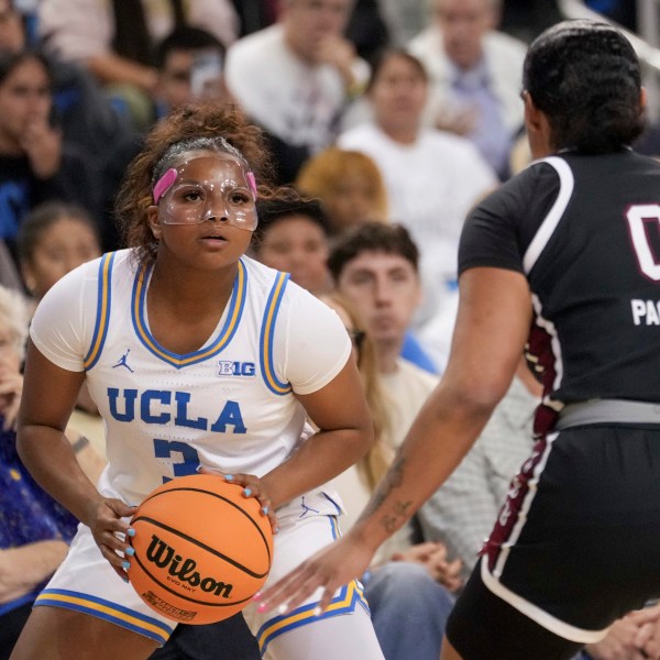 UCLA guard Londynn Jones (3) looks to shoot against South Carolina guard Te-Hina Paopao (0) during the second half of an NCAA college basketball game, Sunday, Nov. 24, 2024, in Los Angeles. (AP Photo/Eric Thayer)