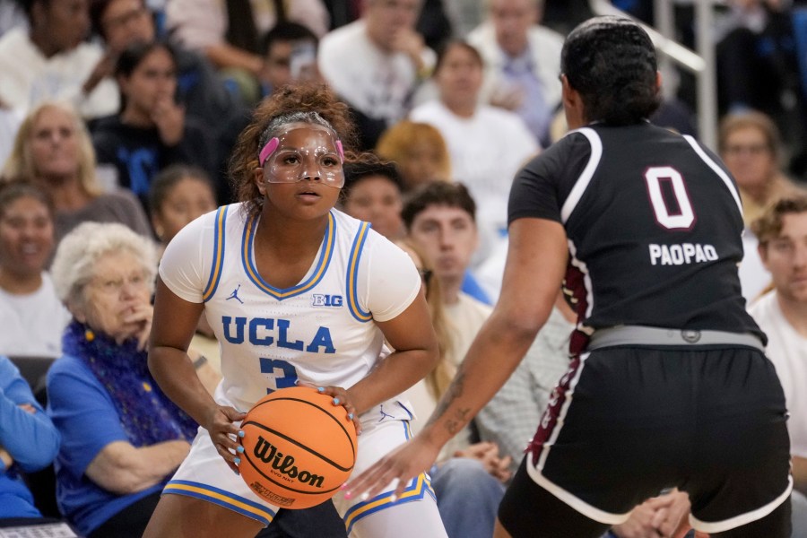 UCLA guard Londynn Jones (3) looks to shoot against South Carolina guard Te-Hina Paopao (0) during the second half of an NCAA college basketball game, Sunday, Nov. 24, 2024, in Los Angeles. (AP Photo/Eric Thayer)