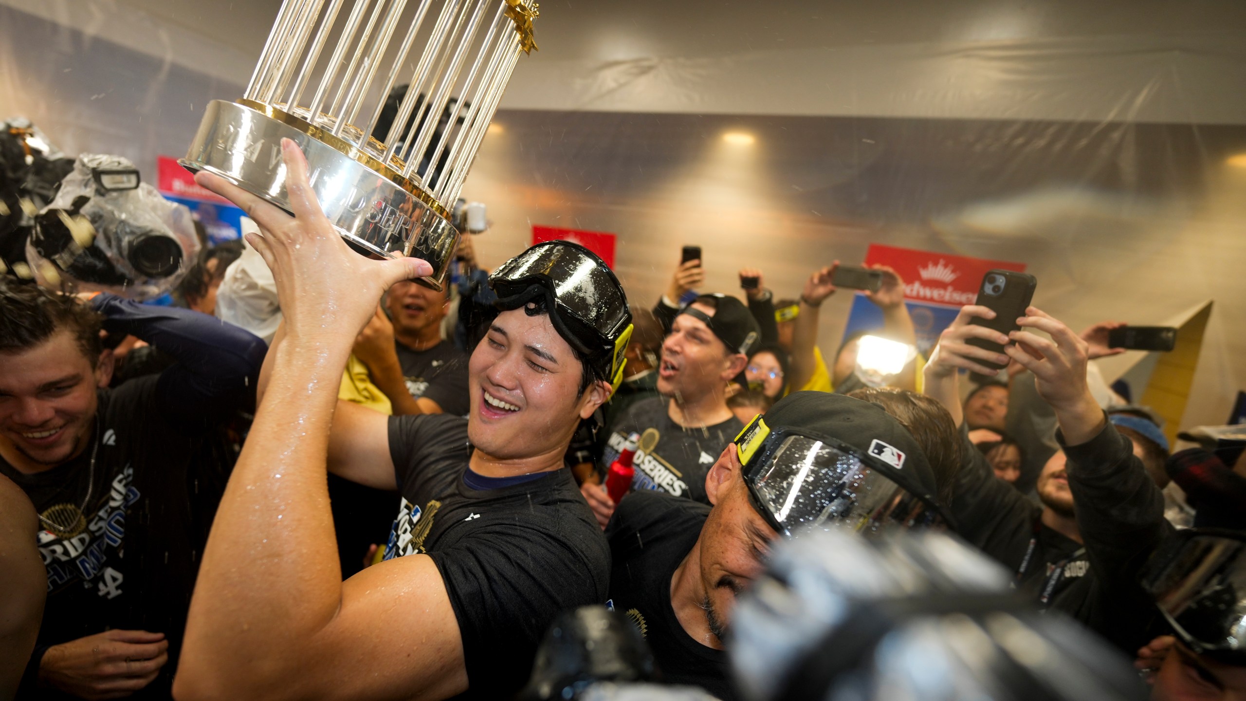 Los Angeles Dodgers' Shohei Ohtani celebrates in the locker room after their win against the New York Yankees in Game 5 to win the baseball World Series, Thursday, Oct. 31, 2024, in New York. (AP Photo/Ashley Landis)