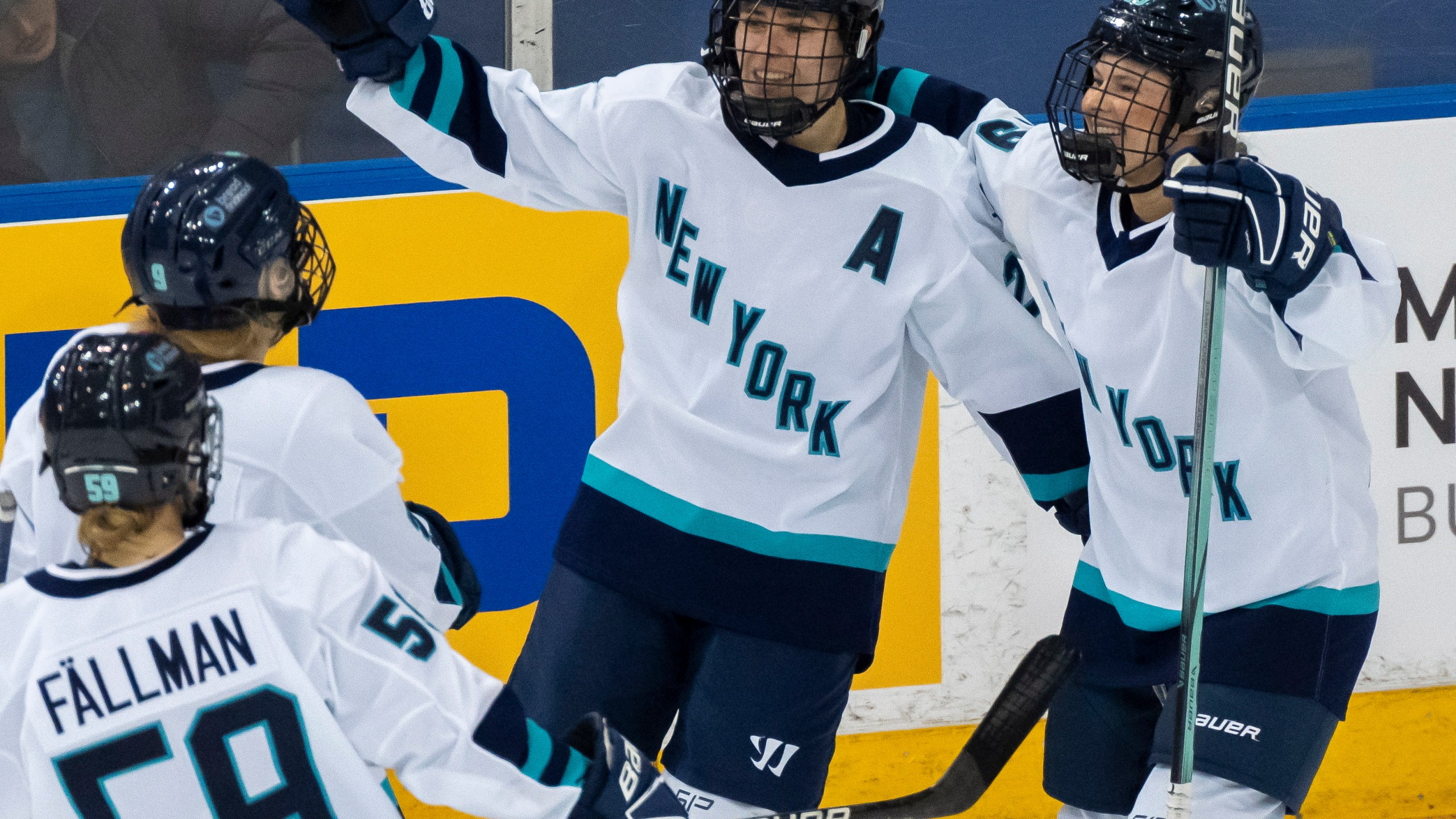 FILE - New York forward Alex Carpenter, center, is congratulated by teammates Paetyn Levis (19), Jade Downie-Landry (9) and Johanna Fallman after scoring against Toronto during the third period of a PWHL hockey game in Toronto, Ontario, Monday, Jan. 1, 2024. (Frank Gunn/The Canadian Press via AP, File)