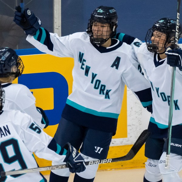 FILE - New York forward Alex Carpenter, center, is congratulated by teammates Paetyn Levis (19), Jade Downie-Landry (9) and Johanna Fallman after scoring against Toronto during the third period of a PWHL hockey game in Toronto, Ontario, Monday, Jan. 1, 2024. (Frank Gunn/The Canadian Press via AP, File)