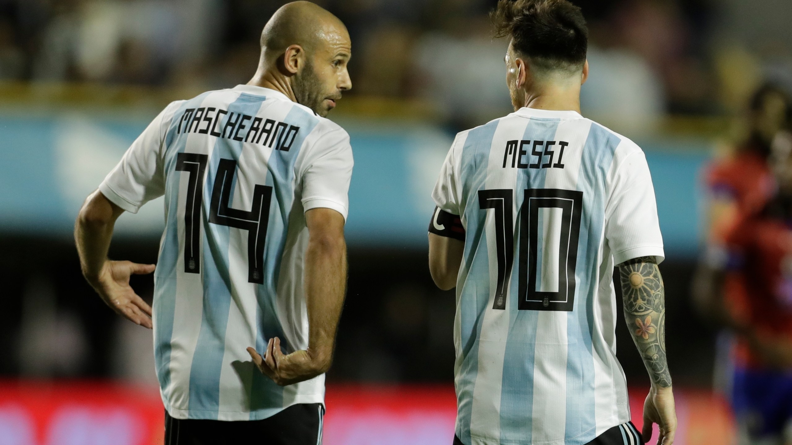 FILE - Argentina's Javier Mascherano, left, and Lionel Messi talk after Messi scored during a friendly soccer match between Argentina and Haiti in Buenos Aires, Argentina, on May 29, 2018. (AP Photo/Victor R. Caivano, File)