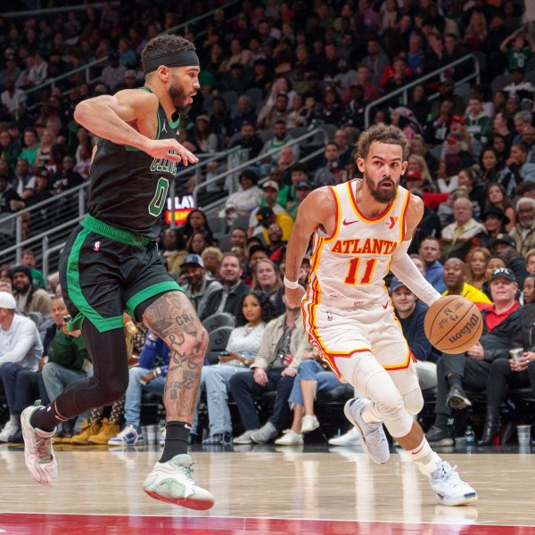 Atlanta Hawks guard Trae Young (11) drives the lane while guarded by Boston Celtics forward Jayson Tatum (0) during the first half of an NBA basketball game, Monday, Nov. 4, 2024, in Atlanta. (AP Photo/Jason Allen)