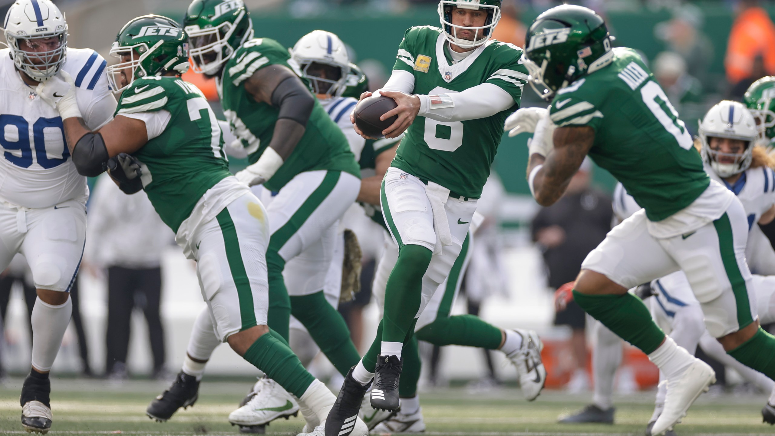 New York Jets quarterback Aaron Rodgers (8) hands off the ball to New York Jets running back Braelon Allen (0) during the second quarter of an NFL football game, Sunday, Nov. 17, 2024, in East Rutherford, N.J. (AP Photo/Adam Hunger)