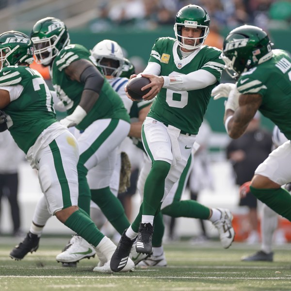 New York Jets quarterback Aaron Rodgers (8) hands off the ball to New York Jets running back Braelon Allen (0) during the second quarter of an NFL football game, Sunday, Nov. 17, 2024, in East Rutherford, N.J. (AP Photo/Adam Hunger)