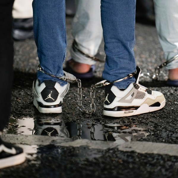 FILE - Shackled Ecuadorian migrants line up to board a plane for deportation from the Albrook airport in Panama City, Aug. 29, 2024. (AP Photo/Matias Delacroix, File)