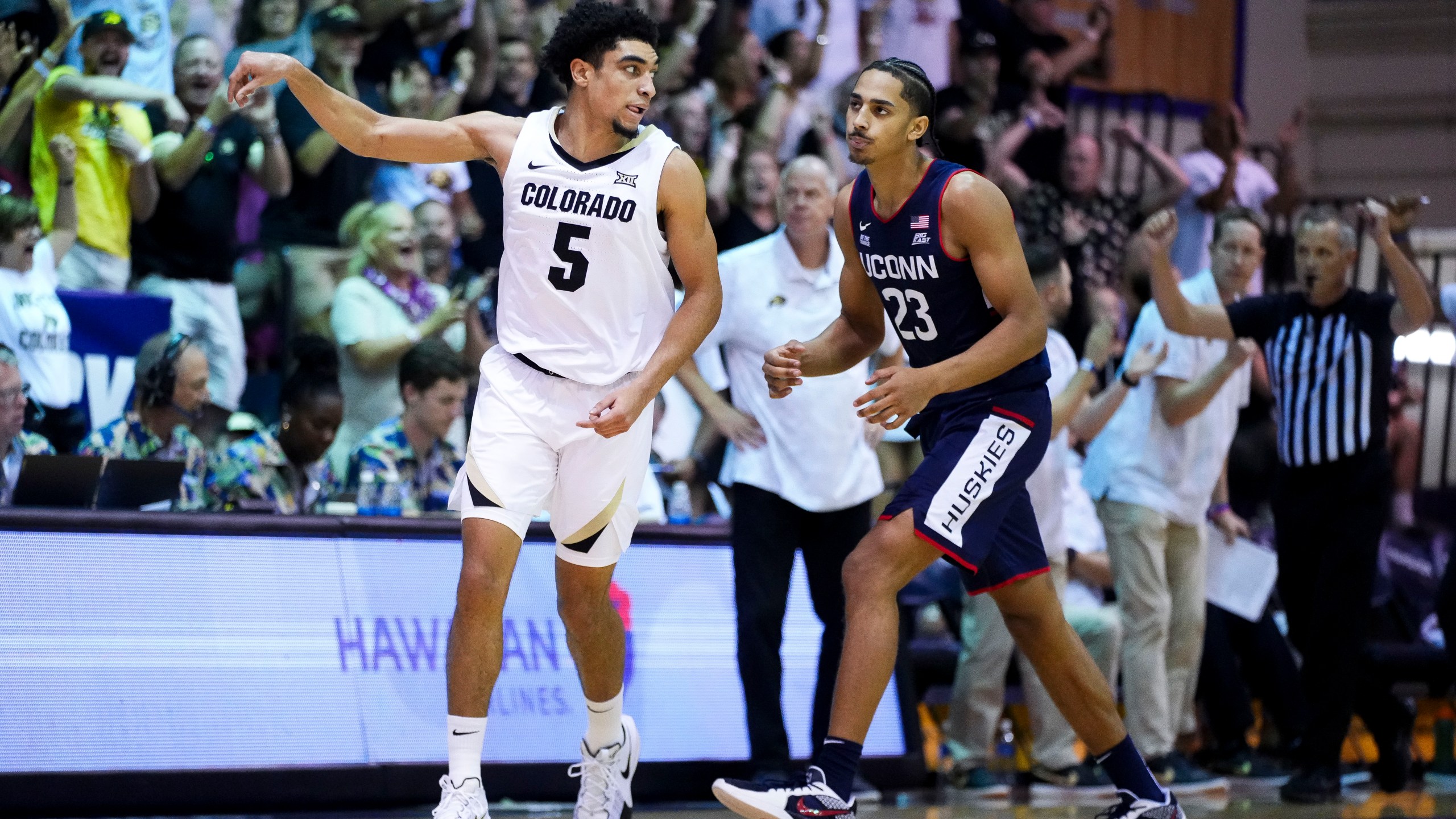 Colorado guard RJ Smith (5) reacts after a basket as UConn forward Jayden Ross (23) looks on during the second half of an NCAA college basketball game at the Maui Invitational Tuesday, Nov. 26, 2024, in Lahaina, Hawaii. Colorado won 73-72. (AP Photo/Lindsey Wasson)