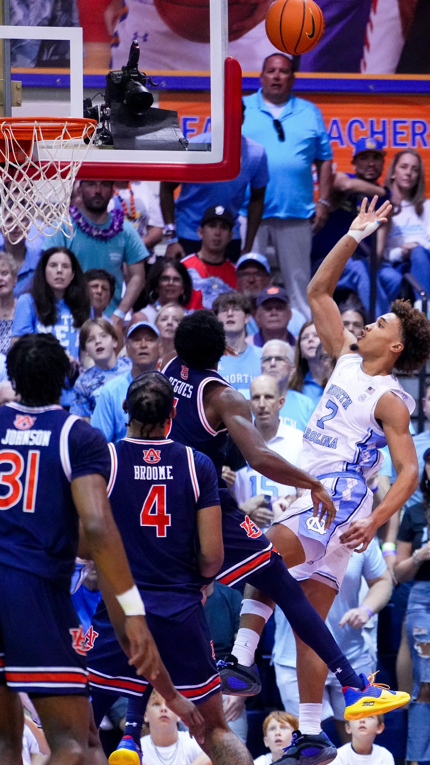 North Carolina guard Seth Trimble (7) scores against Auburn guard JP Pegues during the first half of an NCAA college basketball game at the Maui Invitational Tuesday, Nov. 26, 2024, in Lahaina, Hawaii. (AP Photo/Lindsey Wasson)