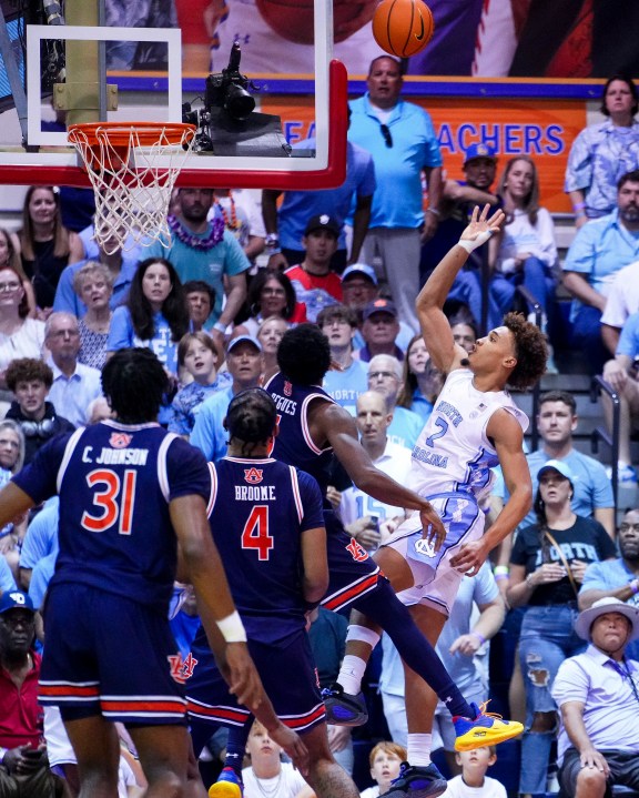 North Carolina guard Seth Trimble (7) scores against Auburn guard JP Pegues during the first half of an NCAA college basketball game at the Maui Invitational Tuesday, Nov. 26, 2024, in Lahaina, Hawaii. (AP Photo/Lindsey Wasson)