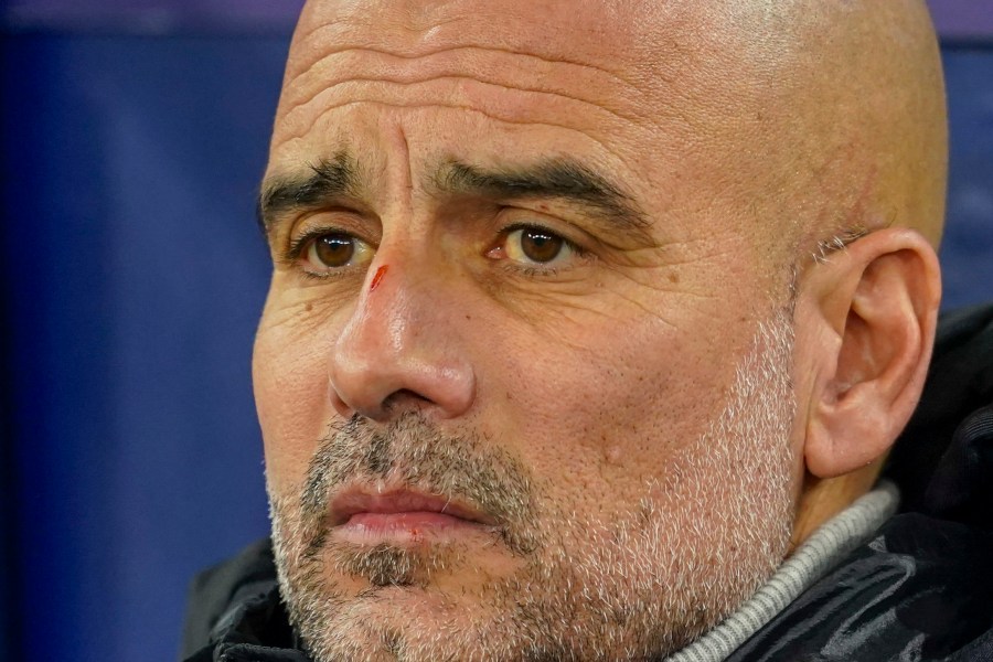 Manchester City's head coach Pep Guardiola takes his seat on the bench before the Champions League opening phase soccer match between Manchester City and Feyenoord at the Etihad Stadium in Manchester, England, Tuesday, Nov. 26, 2024. (AP Photo/Dave Thompson)