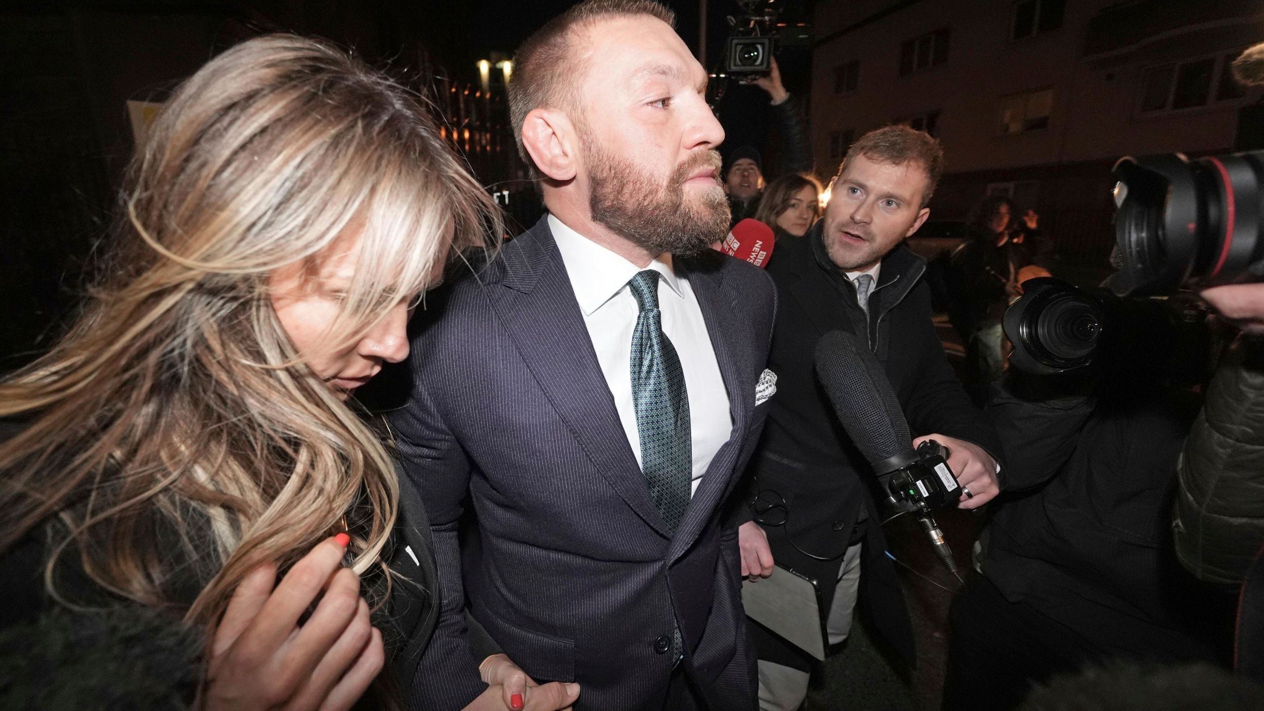 Mixed martial arts fighter Conor McGregor and partner Dee Devlin leave the High Court in Dublin, Ireland, Friday Nov. 22, 2024. (Brian Lawless/PA via AP)